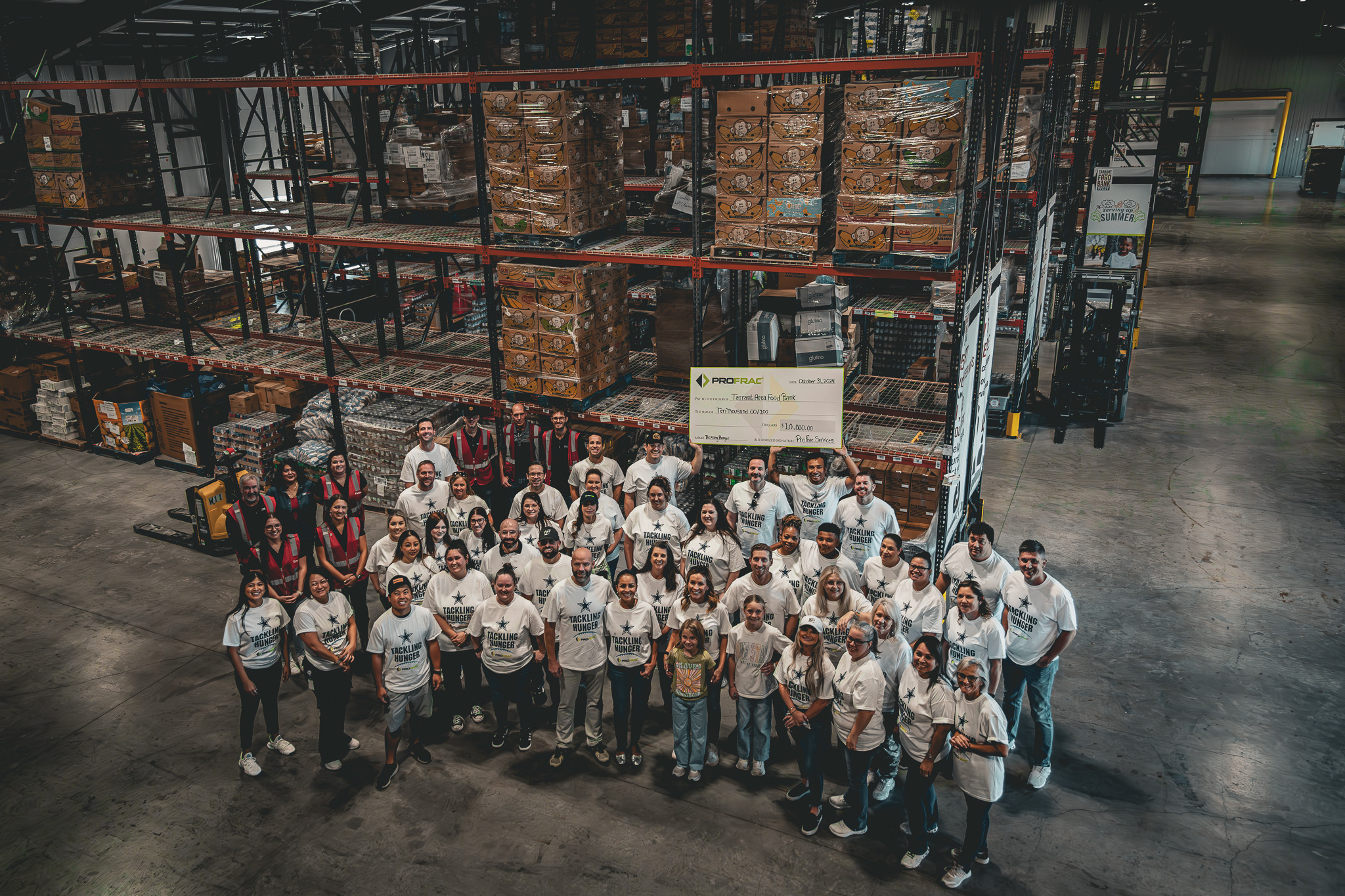 A group picture of ProFrac and PF Holdings employees during a charitable event at the Tarrant Area Food Bank